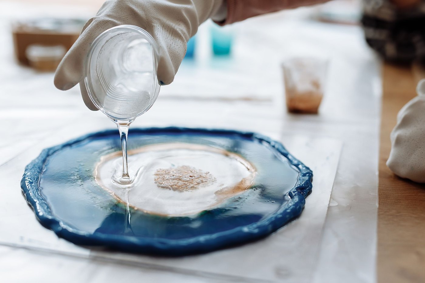 Pouring resin into a blue silicone mould